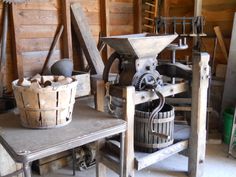 an old fashioned machine is sitting on a table in a room with wooden walls and flooring