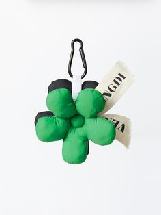 a green stuffed animal hanging from a hook