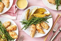 several plates with different types of food on them and silverware next to each other