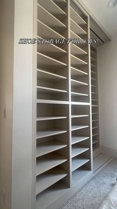 an empty room with white shelves and carpeted flooring in the middle of it