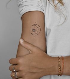 a woman's arm with a small tattoo on the left side of her arm