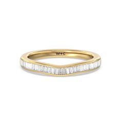 a yellow gold wedding band with baguettes in the center and side stones on top