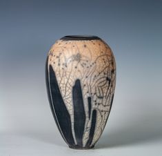 a black and white vase sitting on top of a table