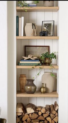 the shelves are filled with books, vases and other decorative items on top of them