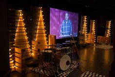 an empty room with lights on the walls and a projector screen in front of it