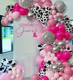 pink, black and white balloons are arranged in the shape of a cowgirl letter