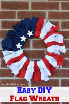 an american flag wreath hanging on a brick wall next to a sign that says diy wreath