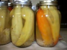 three jars filled with pickles and carrots