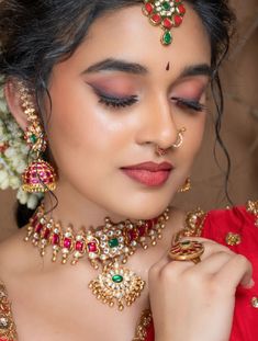 a woman wearing an elaborate necklace and earrings