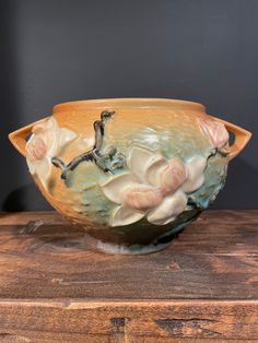 a ceramic bowl sitting on top of a wooden table