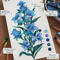 a painting with blue flowers on it next to some paint and crayons in the background