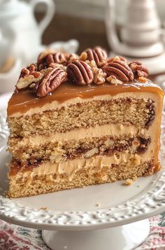 a piece of cake on a plate with pecans