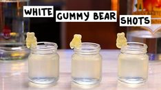 three jars filled with gummy bears sitting on top of a table