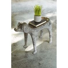 an elephant shaped table with a potted plant on top