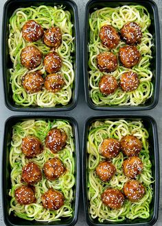 four black trays filled with meatballs and zucchini noodles covered in sauce