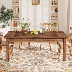 a dining room table with chairs and an area rug in front of the table is a potted plant