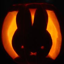 a carved pumpkin with an image of a rabbit in it's face and ears