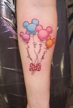 a person with a tattoo on their leg that has some balloons attached to the legs