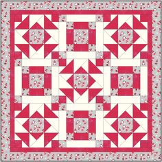 a red and white quilt with an arrow pattern on the center, as well as two smaller triangles