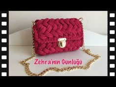 a red handbag with a chain attached to it