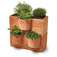 three wooden planters filled with plants on top of each other