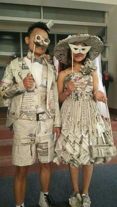 two people dressed up in newspaper costumes