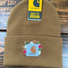 a brown beanie with a patch on it