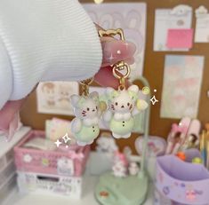 hello kitty keychains are hanging from a desk with other items in the background