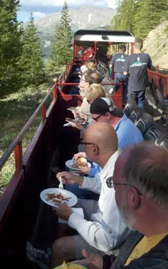 people are eating in the back of a train