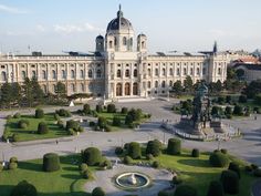 an aerial view of a large building in the middle of a park