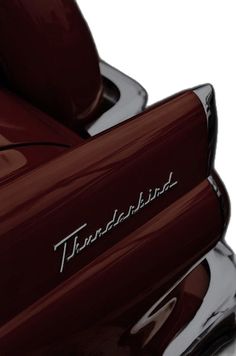 the front end of a red motorcycle that says, thunderbird