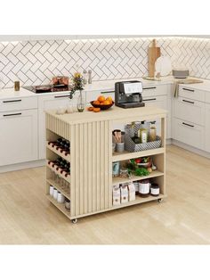 a kitchen island with food and drinks on it in the middle of a wooden floor