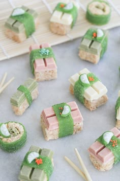 small desserts are arranged on a tray with chopsticks