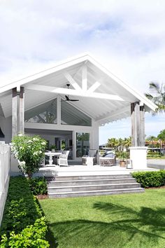 a white house with a covered porch and steps leading up to the front door area