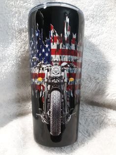 a black tumbler with an american flag and motorcycle design on it's side