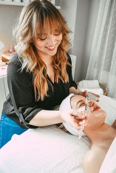 a woman is getting her face examined by a doctor