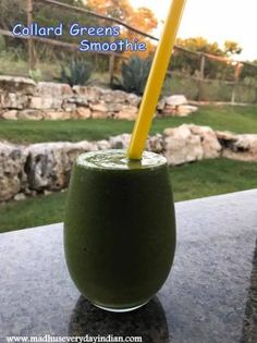 a green smoothie with a yellow straw in it