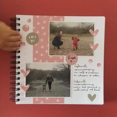 a child's hand holding up a scrapbook with photos and hearts