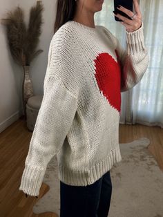 Adorable Oversized Off White Loose Knit Sweater ft. Big Red Heart Detail on Front. A great year round sweater but so adorable for Valentines day! Maclaine is 5'7 wearing a size SMALL. Model is 5’4 wearing a size LARGE. This has a naturally oversized fit! White Heart Print Sweater For Winter, Cute Fall Cable Knit Sweater, Cute Cable Knit Sweater For Fall, Cute Cable Knit Fall Sweater, White Heart Sweater For Winter, Cute Oversized Chunky Knit Sweater, Cute Winter Sweater With Heart Print, Cute Heart Print Winter Sweater, Cute Chunky Knit Sweater For Fall