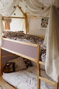 a bunk bed with curtains and pillows on it