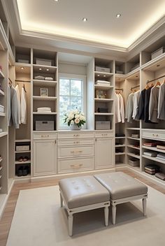 a large walk in closet with lots of clothes