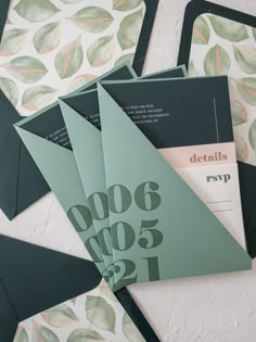 some green and black envelopes on a table