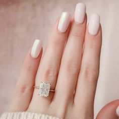 a woman's hand with a ring on it and a diamond in the middle