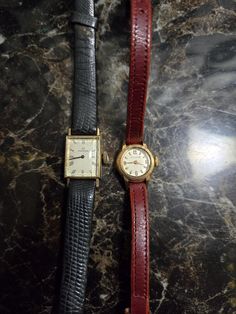 This is a lot of 2 vintage 1940s - 1950s era solid Gold Movado women's wrist watches. The red strap round dial movado watch has an 18k Gold  watch case that is marked on the inside and tests positively for 18k Gold. The other watch is a rectangular movement 14k gold watch case Womens movado watch that is marked on the back on both sides of the case and the watch case test positivelyfor 14k gold. Both watches are in good condition and currently run when wound although I cannot guarantee that they will run at time of sale because they are old watches and I am unsure of the last time that they were serviced, so they are both being sold as not working. Both watches sold together not separate. Sold as is. Vintage Gold Watches, Vintage Gold Watch, Movado Watch, Round Watch, Old Watches, Square Watch, Women Wrist Watch, Watch Case, Wrist Watches