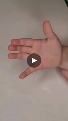 a person's hand reaching out to touch the surface of a counter top with their thumb