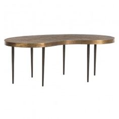 an oval wooden table with metal legs and a gold finish on the top, against a white background