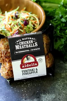 chicken meatballs in a bag next to a bowl of salad