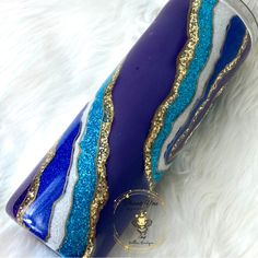 a purple and blue purse sitting on top of a white furnishing covered floor