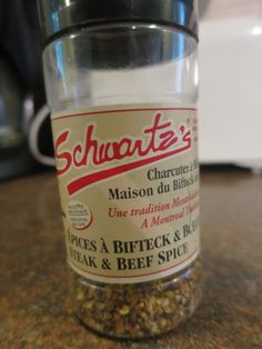 a glass jar filled with granola sitting on top of a counter