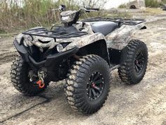 an atv is parked in the dirt